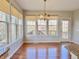 Bright dining area with hardwood floors, large windows and stylish chandelier at 3926 Castle Rock Dr, Zionsville, IN 46077