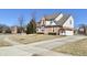 Brick home with driveway, manicured lawn, and mature trees in a residential neighborhood at 3926 Castle Rock Dr, Zionsville, IN 46077