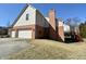 Home exterior with a two-car garage, a brick chimney and a side entrance at 3926 Castle Rock Dr, Zionsville, IN 46077
