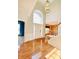 Bright foyer with gleaming hardwood floors, staircase, and a view into adjacent living spaces at 3926 Castle Rock Dr, Zionsville, IN 46077