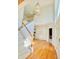 Open foyer featuring hardwood floors, staircase, and a view into other living spaces at 3926 Castle Rock Dr, Zionsville, IN 46077