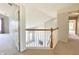 Upper hallway featuring a wooden staircase railing, neutral carpet, and gray walls at 3926 Castle Rock Dr, Zionsville, IN 46077