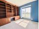Bright home office with custom built-in shelving, desk space, and a large window at 3926 Castle Rock Dr, Zionsville, IN 46077