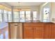 Bright kitchen showcasing the sink with stainless steel dishwasher and window lighting at 3926 Castle Rock Dr, Zionsville, IN 46077