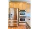 Modern kitchen showcasing stainless steel refrigerator, double oven, and granite countertops at 3926 Castle Rock Dr, Zionsville, IN 46077