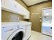 Laundry room with washer, dryer, and cabinets at 3926 Castle Rock Dr, Zionsville, IN 46077