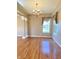 Inviting living room with beautiful wood floors, large windows, and a decorative chandelier at 3926 Castle Rock Dr, Zionsville, IN 46077