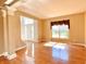 Light-filled living room with hardwood floors, decorative columns, and a large window at 3926 Castle Rock Dr, Zionsville, IN 46077