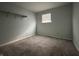 Cozy bedroom with neutral carpet and a bright window at 4121 Fletcher Ave, Indianapolis, IN 46203