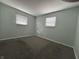 Bedroom with neutral carpet and two windows at 4121 Fletcher Ave, Indianapolis, IN 46203