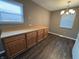 Cozy dining area featuring wood floors, a modern light fixture, and neutral wall color at 4121 Fletcher Ave, Indianapolis, IN 46203