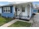 Quaint home featuring a freshly painted blue and white exterior with an inviting front porch at 4121 Fletcher Ave, Indianapolis, IN 46203