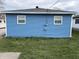 A charming blue garage features traditional siding, two windows and a clean and tidy exterior at 4121 Fletcher Ave, Indianapolis, IN 46203