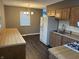Open kitchen and dining area combination with wood cabinets and modern appliances at 4121 Fletcher Ave, Indianapolis, IN 46203