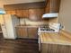 Well-lit kitchen showcasing classic wood cabinets, laminate countertops, and a white refrigerator at 4121 Fletcher Ave, Indianapolis, IN 46203