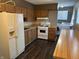 Spacious kitchen layout including wood cabinets, a dining area, and laundry hookups at 4121 Fletcher Ave, Indianapolis, IN 46203