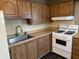 Cozy kitchen showcasing wood cabinets, modern appliances, and a stainless steel sink at 4121 Fletcher Ave, Indianapolis, IN 46203