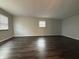 Open living area featuring dark hardwood floors, neutral walls, and natural light at 4121 Fletcher Ave, Indianapolis, IN 46203