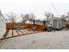Fully fenced backyard with detached garage, wooden deck, and stone patio at 4711 East 21St St, Indianapolis, IN 46218