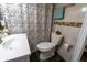 Updated full bathroom with stylish vanity, toilet, and shower with decorative curtain at 4711 East 21St St, Indianapolis, IN 46218