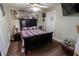 Bedroom with a large bed, ceiling fan, mounted TV, and neutral colored walls at 4711 East 21St St, Indianapolis, IN 46218