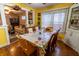 Dining area open to living room, featuring wood floors, a large window, and seating for six at 4711 East 21St St, Indianapolis, IN 46218