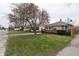 Traditional home with an inviting front yard and mature flowering trees at 4711 East 21St St, Indianapolis, IN 46218