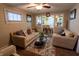 A bright living room boasts comfortable seating, an elegant glass coffee table, and a seamless transition to the dining area at 4711 East 21St St, Indianapolis, IN 46218