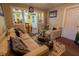 Inviting living room featuring a cozy sofa, glass coffee table, and an open view into the adjacent dining area at 4711 East 21St St, Indianapolis, IN 46218