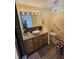 Well lit bathroom featuring a vessel sink, a decorative chandelier, and a hand rail at 4808 N Camelot Dr, Muncie, IN 47304