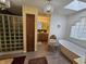 Bright and spacious bathroom with a standalone tub, a glass block shower, and a chandelier at 4808 N Camelot Dr, Muncie, IN 47304