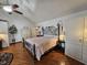 Inviting bedroom featuring wood floors, a ceiling fan, and a decorative wrought iron bed frame at 4808 N Camelot Dr, Muncie, IN 47304