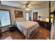 Bedroom featuring hardwood floors, a large painting, and ample natural light through multiple windows at 4808 N Camelot Dr, Muncie, IN 47304