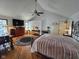Spacious bedroom boasting vaulted ceilings, hardwood floors, a ceiling fan, and large windows at 4808 N Camelot Dr, Muncie, IN 47304