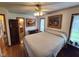 Comfortable bedroom featuring hardwood floors, a ceiling fan, and natural light from the window at 4808 N Camelot Dr, Muncie, IN 47304