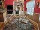 Dining area boasts an elegant chandelier, red walls, and glass-top table with seating for four at 4808 N Camelot Dr, Muncie, IN 47304