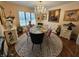 Formal dining room boasts a chandelier, large windows, and seating for eight at 4808 N Camelot Dr, Muncie, IN 47304