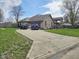 Attractive home boasting a spacious driveway, mature trees, and well-kept front yard at 4808 N Camelot Dr, Muncie, IN 47304