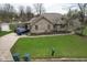 Well-kept home with a large front yard, mature trees, storage shed and private drive at 4808 N Camelot Dr, Muncie, IN 47304