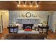 Attractive brick fireplace with a decorative mantel, flanked by stylish lamps and side tables at 4808 N Camelot Dr, Muncie, IN 47304
