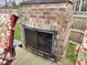 Outdoor brick fireplace with glass doors on a wooden deck with seating and a privacy fence at 4808 N Camelot Dr, Muncie, IN 47304