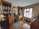 Functional home office with built-in bookshelves, a computer desk, and natural light from the window at 4808 N Camelot Dr, Muncie, IN 47304