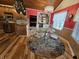 Bright, pink-walled eat-in kitchen with wood floors, chandelier, and glass top table with seating for four at 4808 N Camelot Dr, Muncie, IN 47304