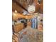 A well-lit kitchen with wood cabinets, stainless steel appliances, granite countertops and a chandelier at 4808 N Camelot Dr, Muncie, IN 47304