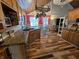 Open-concept kitchen and dining area with hardwood floors and custom cabinetry at 4808 N Camelot Dr, Muncie, IN 47304