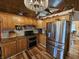 Eat-in kitchen with stainless steel appliances, granite counters, wood cabinets, and hardwood floors at 4808 N Camelot Dr, Muncie, IN 47304