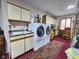 Convenient laundry room equipped with modern appliances, cabinetry, and a sink for added functionality at 4808 N Camelot Dr, Muncie, IN 47304