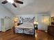 Spacious main bedroom featuring hardwood floors, vaulted ceiling, and wrought iron bed frame at 4808 N Camelot Dr, Muncie, IN 47304