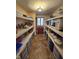 Well-organized pantry with ample shelving and storage, showcasing tile flooring and natural light at 4808 N Camelot Dr, Muncie, IN 47304