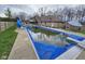 Spacious backyard with large swimming pool, poolside seating, and fenced-in yard at 4808 N Camelot Dr, Muncie, IN 47304